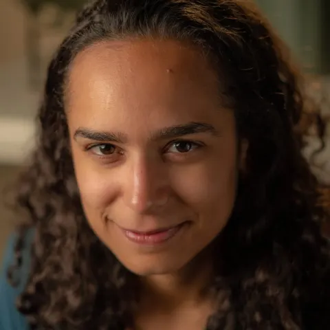 Portrait of a smiling woman with long curly hair